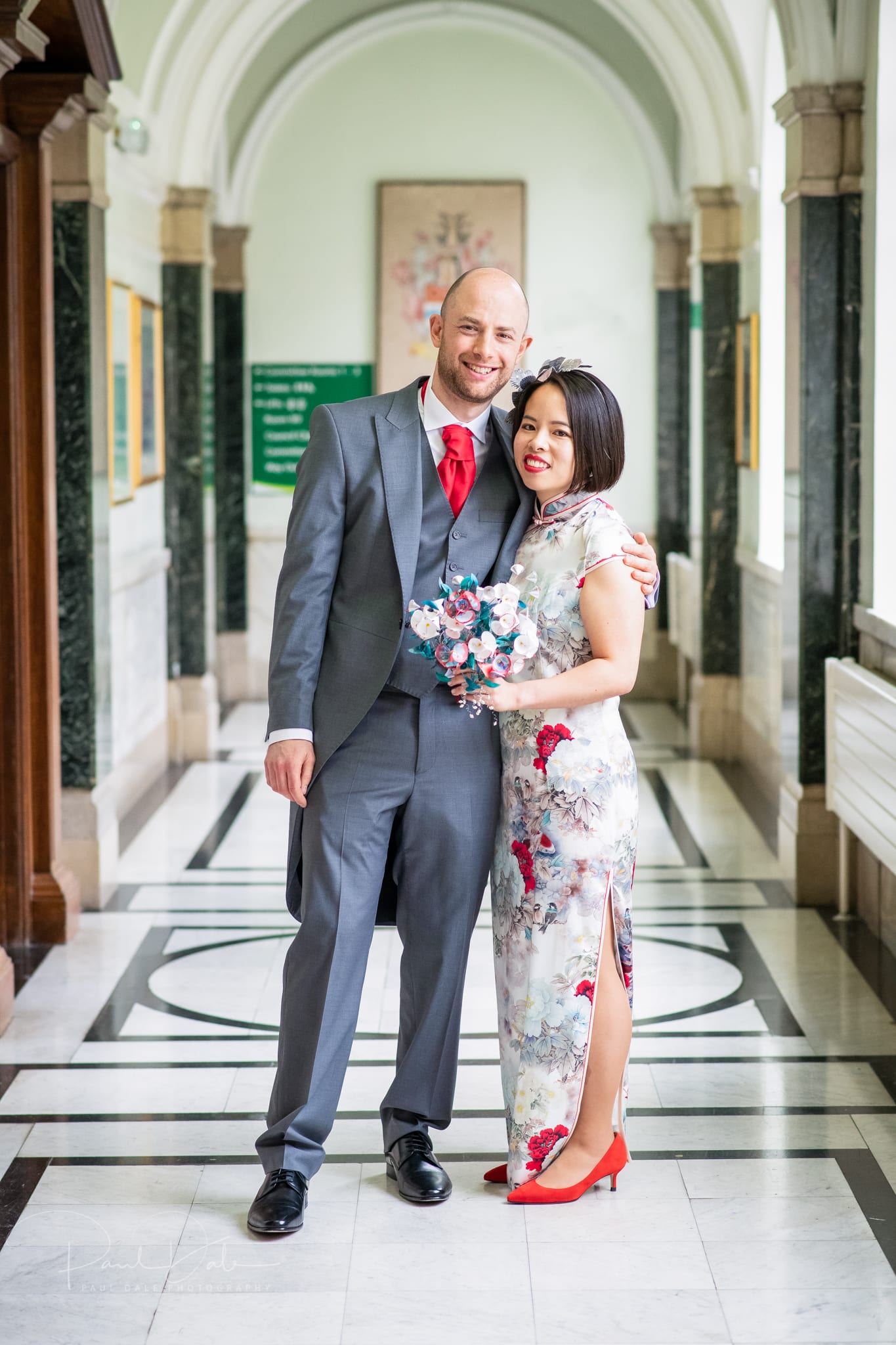 wedding couple looking happy in a corridor bathed in light