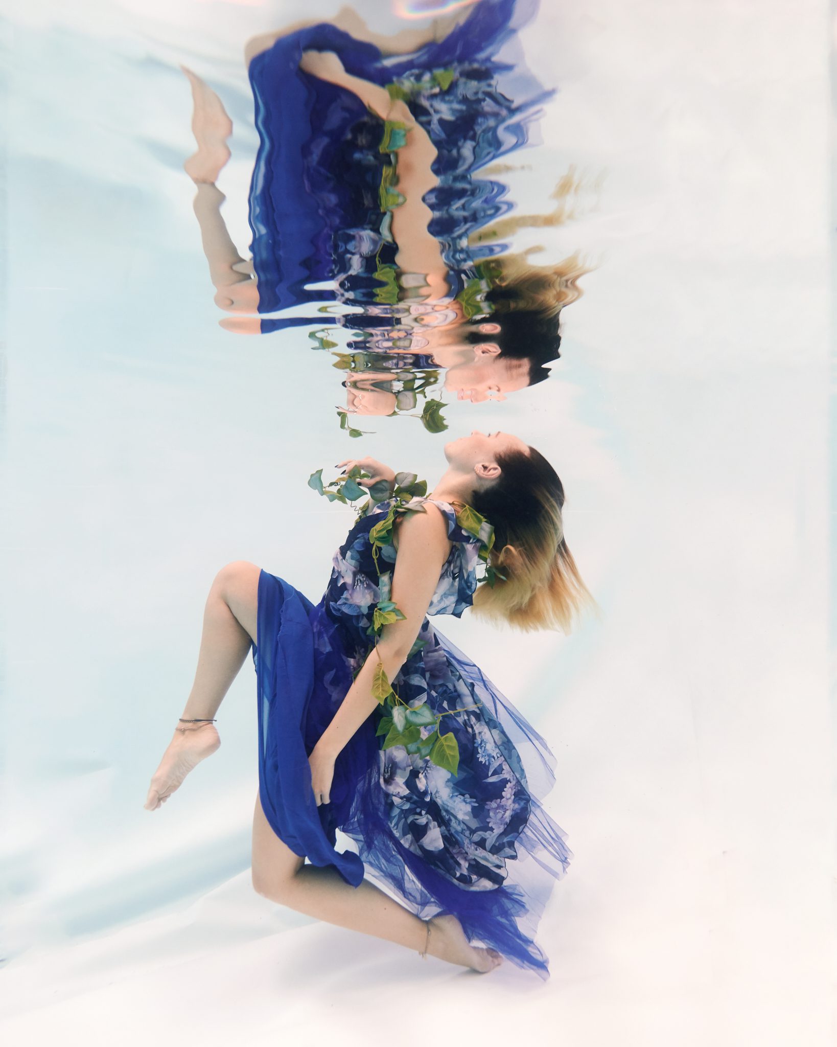 blue dress, flowers, underwater, white backdrop, floating, reflection, stunning underwater image, surrey underwater photography